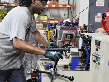 Technician fabricating custom parts for a fire sprinkler system