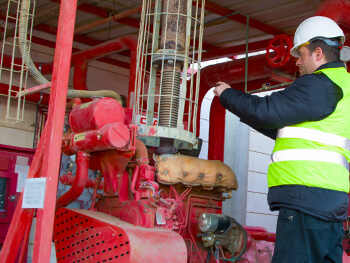 Technician inspecting a fire sprinkler system