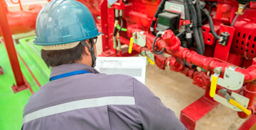 Technician inspecting a fire sprinkler system