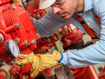 Technician servicing a backflow preventer